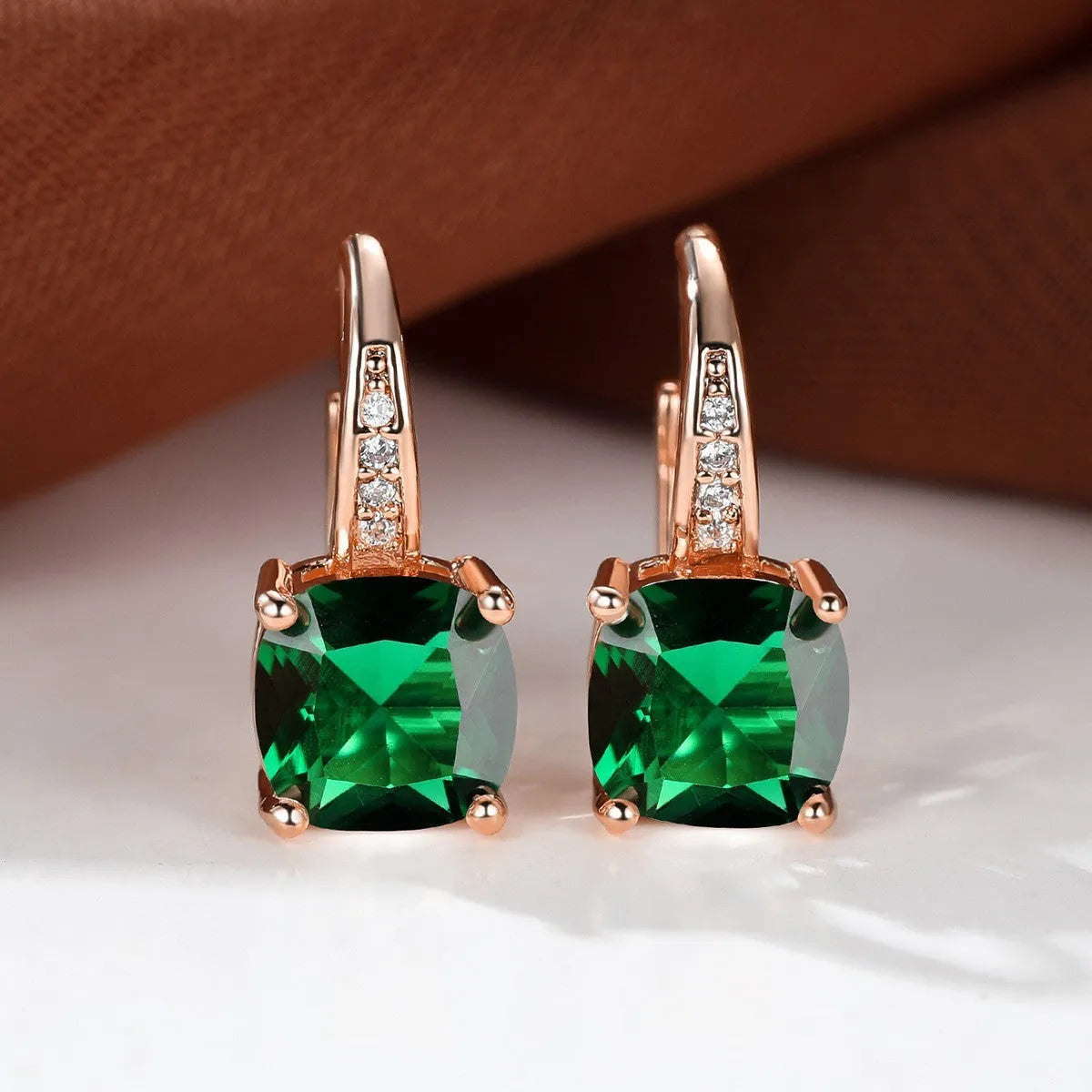 Square geometric ear hook earrings with zircon stones in an electroplated copper setting.