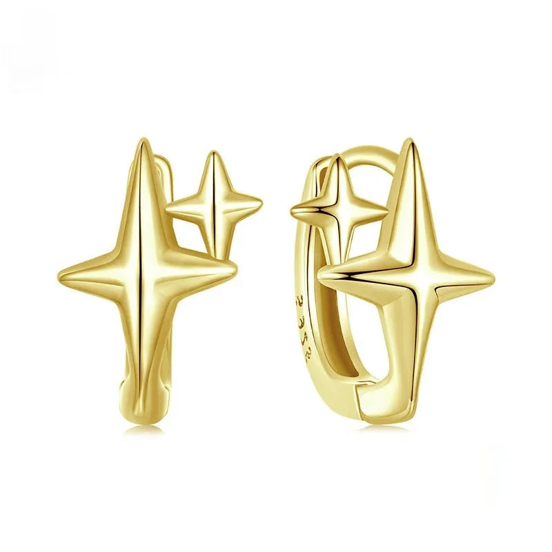 Minimalist oxidised sterling silver star clip-on earrings with XINGX detail on a white background.