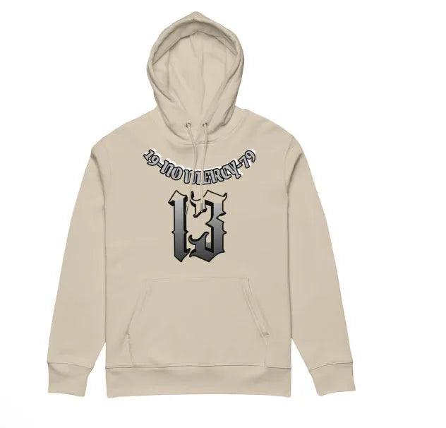 A beige fleece-lined hooded sweater on a hanger, showing its loose pullover fit and front pouch pocket.