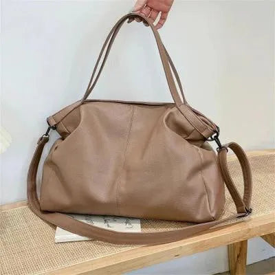 Soft surface messenger bag with adjustable strap showing mobile phone pocket and zipper compartments