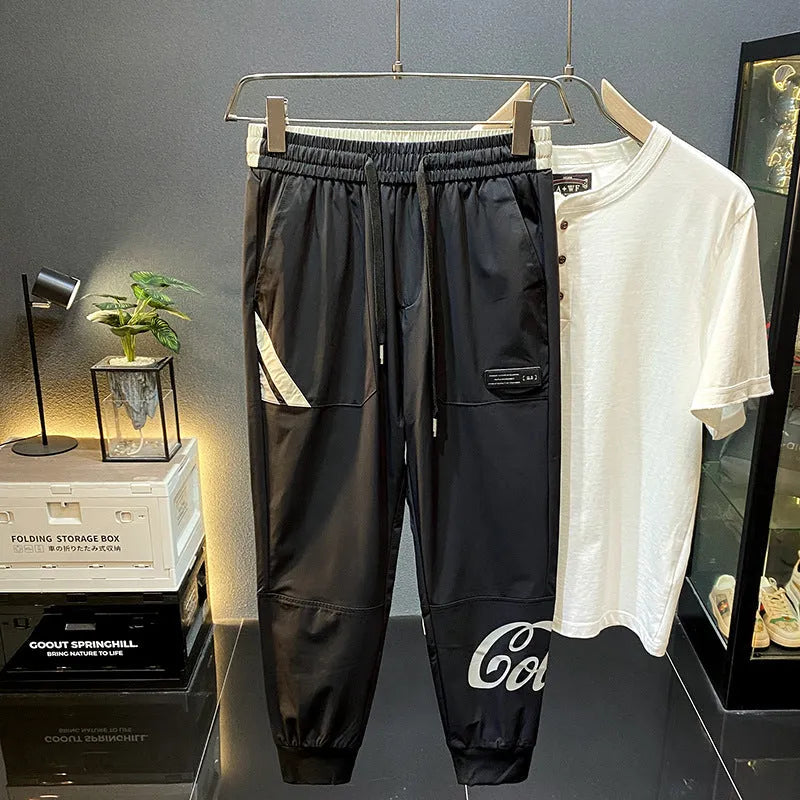 Black men's cropped casual trousers with ankle band, made from ice silk cotton fabric.