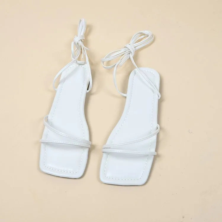Women's flat sandals with ankle ring bandage cloth detail and front lace-up fastening in solid colour