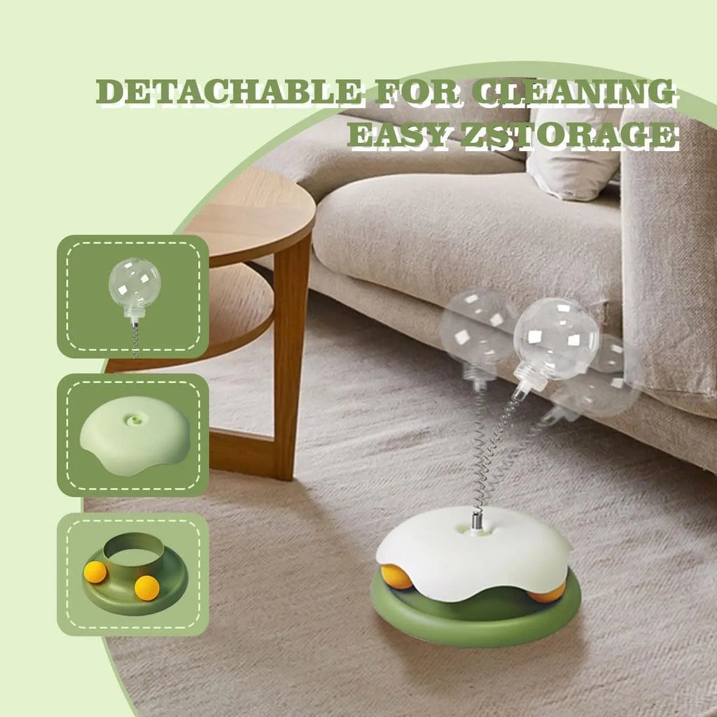 Blue and green cat treat dispenser toy with track ball on a wooden floor
