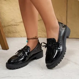 Women's brown and black loafer shoes with decorative bow detailing