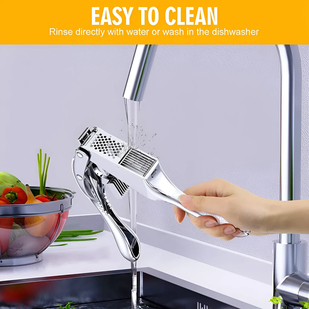 Two-in-one aluminium alloy garlic press with silicone peeler cleaning brush on a kitchen surface