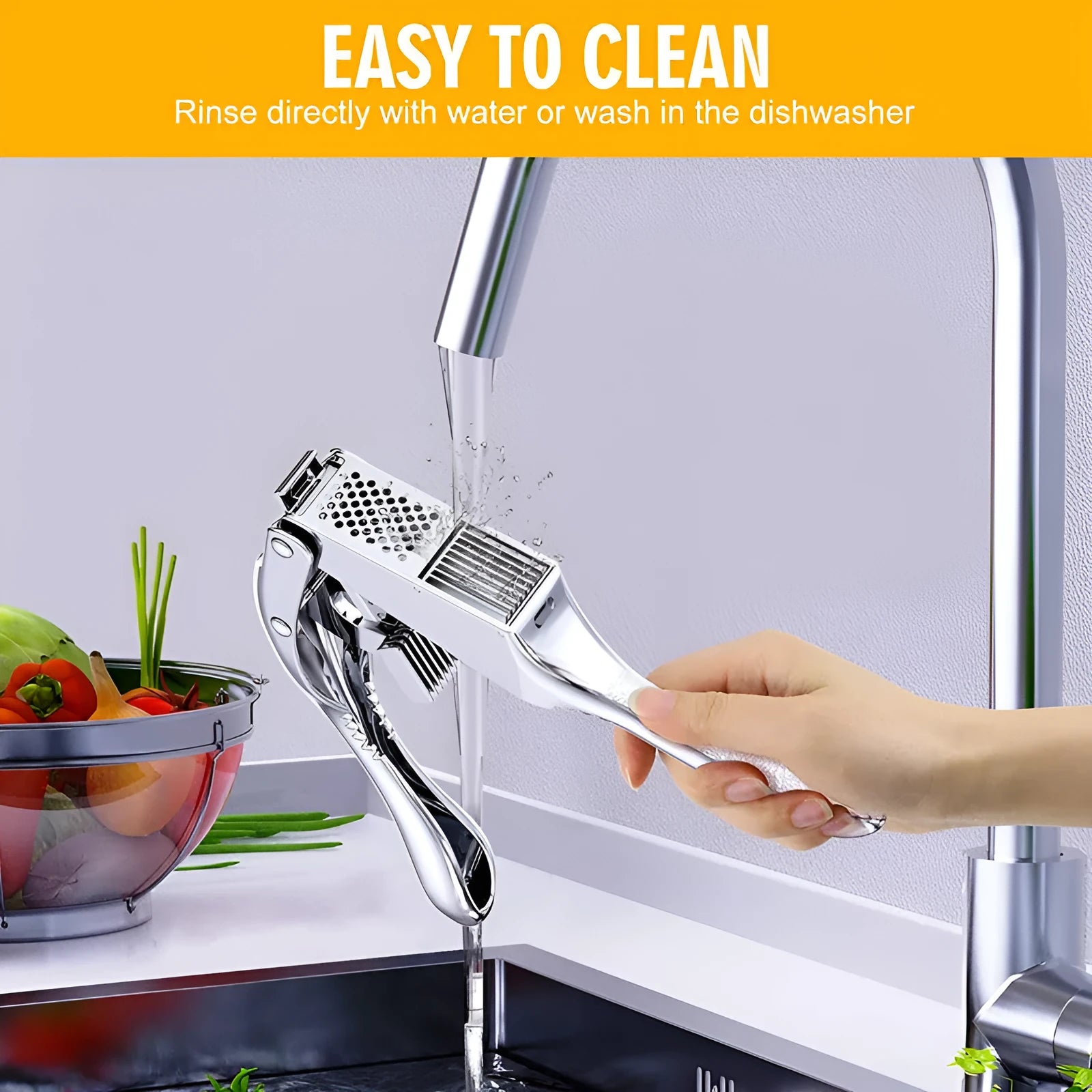 Two-in-one aluminium alloy garlic press with silicone peeler cleaning brush on a kitchen surface