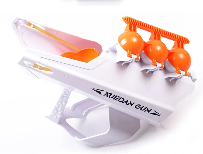 Plastic snowball clip launcher tool in black, green, and orange colours with strong rubber band
