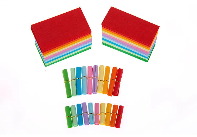 Colourful assortment of small paper scrolls with metal eyelets for drift bottle messages.