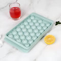 Blue silicone ice cube tray with lid showing 33 round grids for homemade ice making