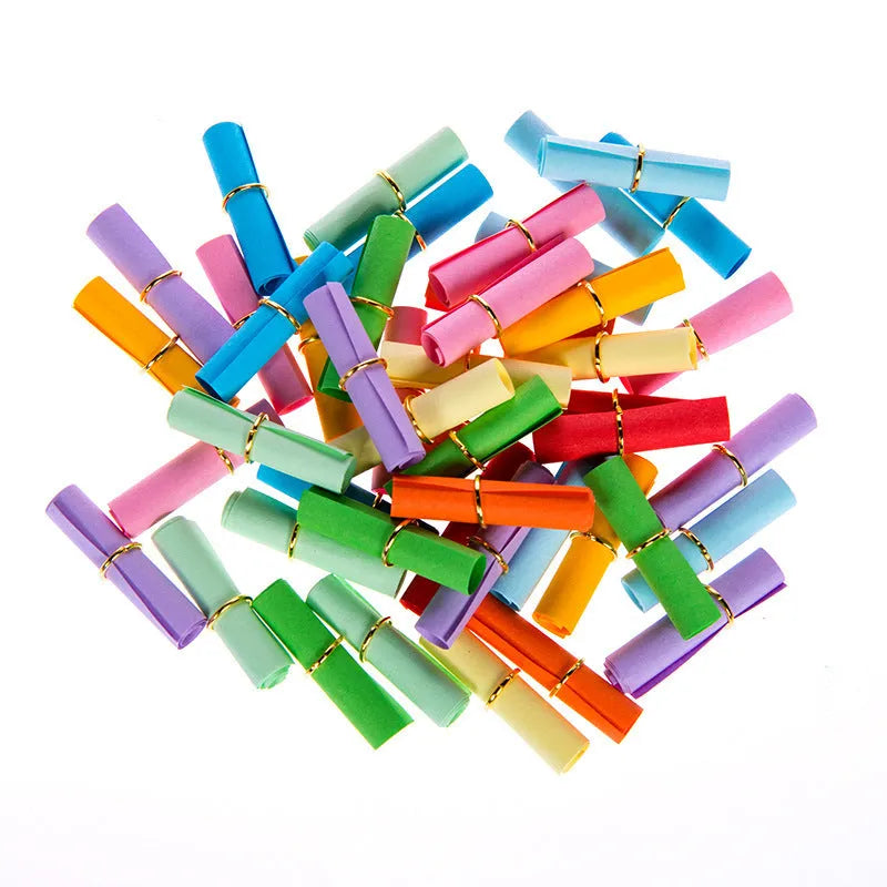 Colourful assortment of small paper scrolls with metal eyelets for drift bottle messages.