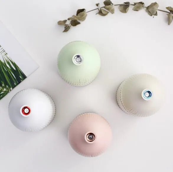 White ultrasonic aromatherapy diffuser and humidifier with LED light, 80mm diameter