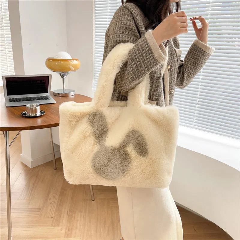 Soft plush shoulder bag with cartoon rabbit ears in one of six solid colours.