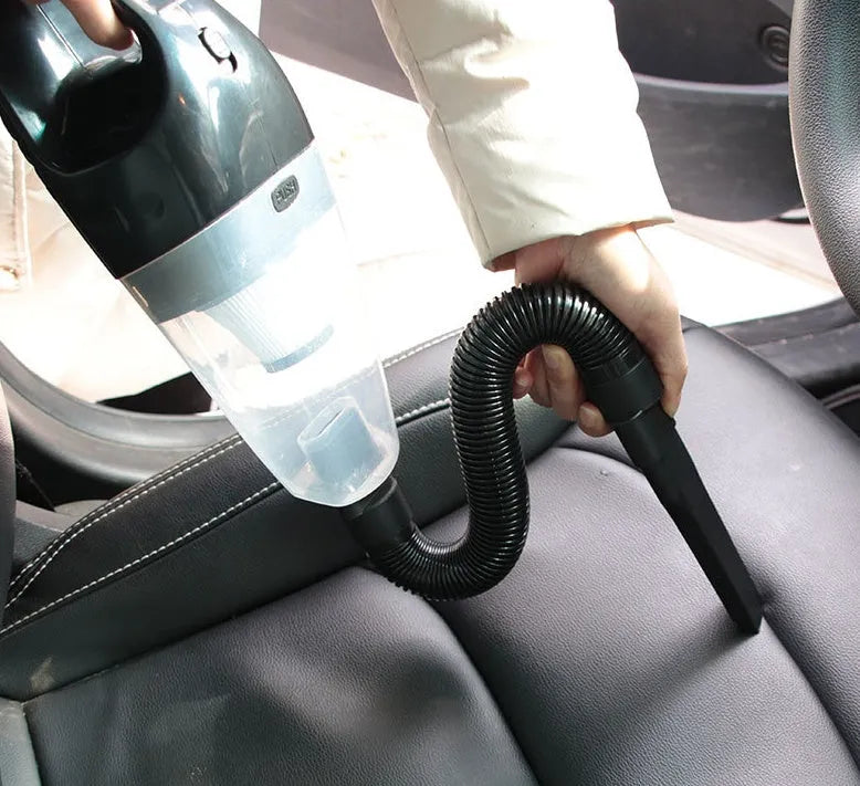 Portable orange handheld car vacuum cleaner with nozzle attachments for 12V vehicle use