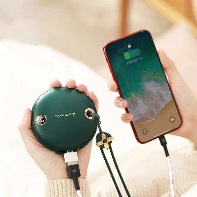 Green hand warmer power bank with digital display showing battery percentage, next to charging cable