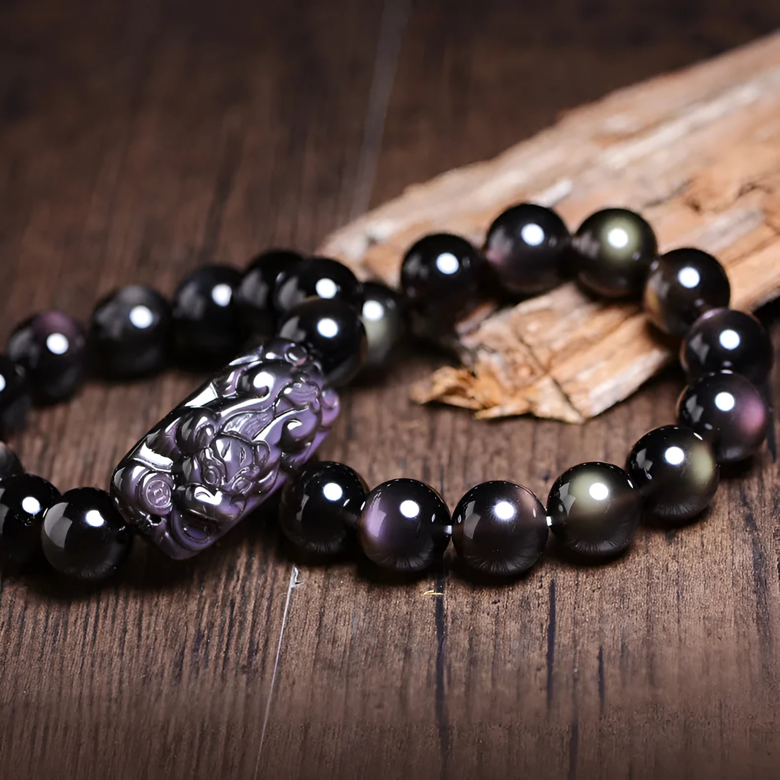 Natural crystal bracelet with a Pi Xiu charm and icy obsidian beads in geometric ethnic style.