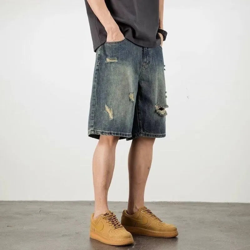 Blue distressed retro denim shorts for men on a white background