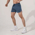 Men's black polyester straight-leg sports shorts on a hanger, showing the athletic cut and shorts length.