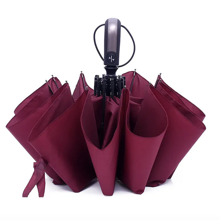 Triple-fold automatic open business umbrella in black, showing palace-style shape and rubber handle.