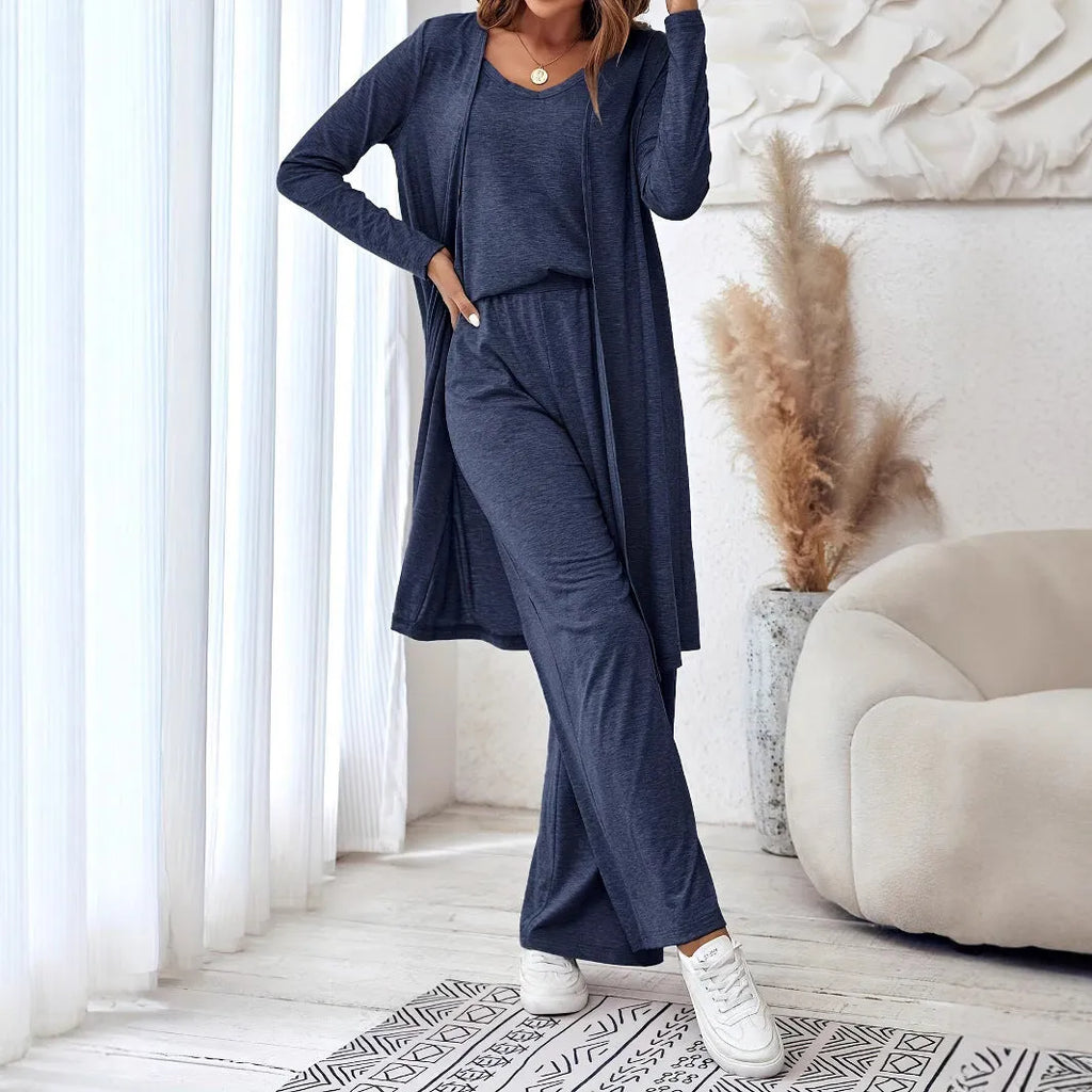 Blue women's two piece casual suit with long sleeve top, trousers, and suspenders on a hanger.