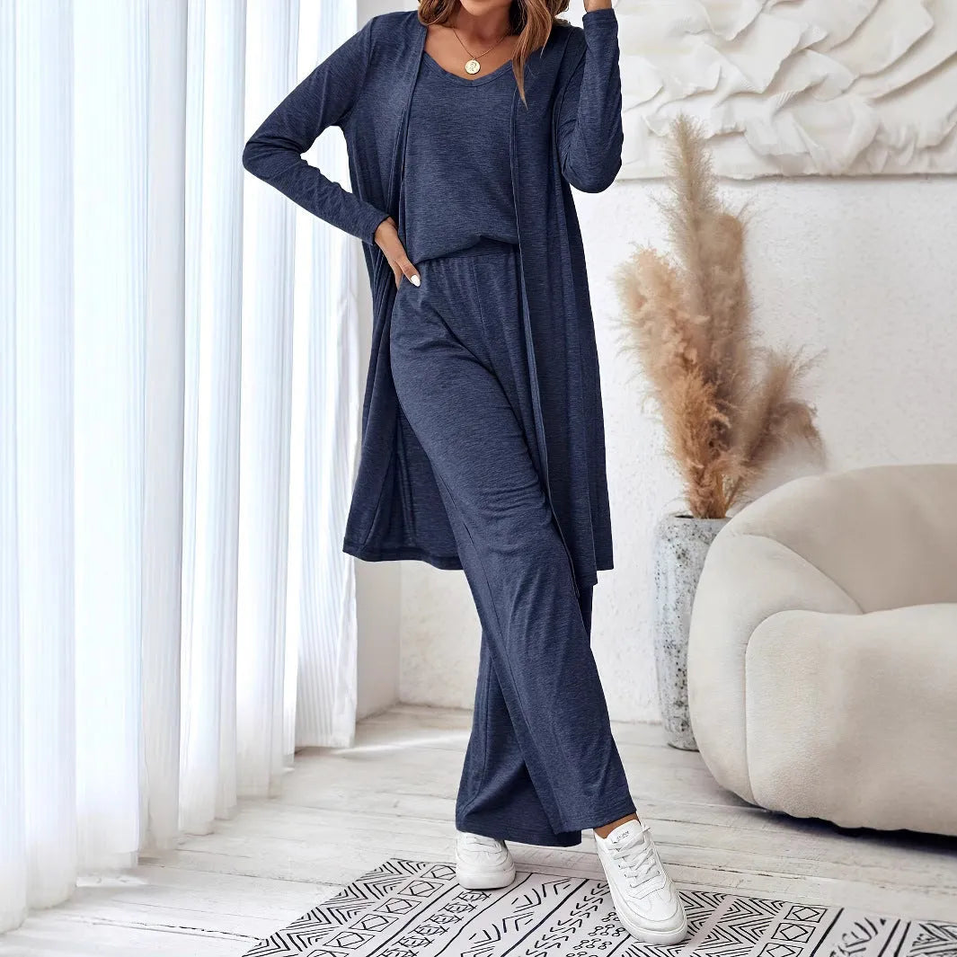 Blue women's two piece casual suit with long sleeve top, trousers, and suspenders on a hanger.