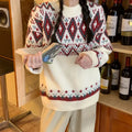 Red and white striped loose fit pullover knitted top with long sleeves on a mannequin.