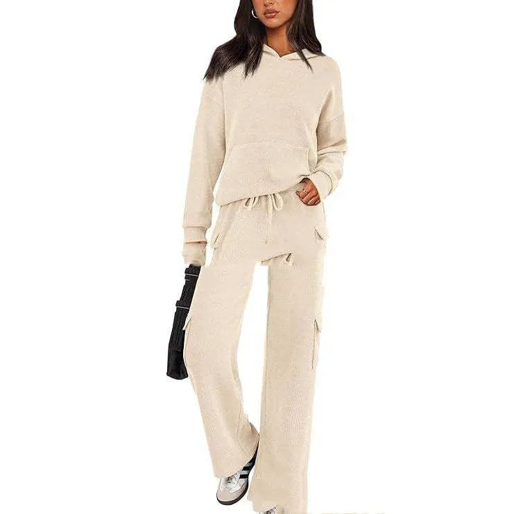 Women's two-piece polyester leisure suit in a solid colour, showing long sleeves and full-length trousers.