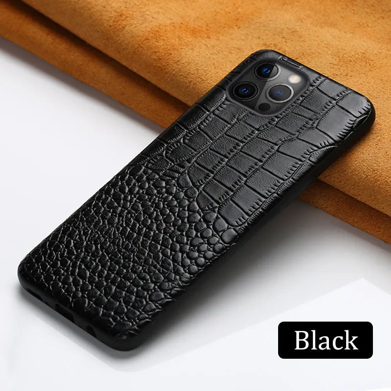 Black leather iPhone case with a crocodile pattern texture lying flat.