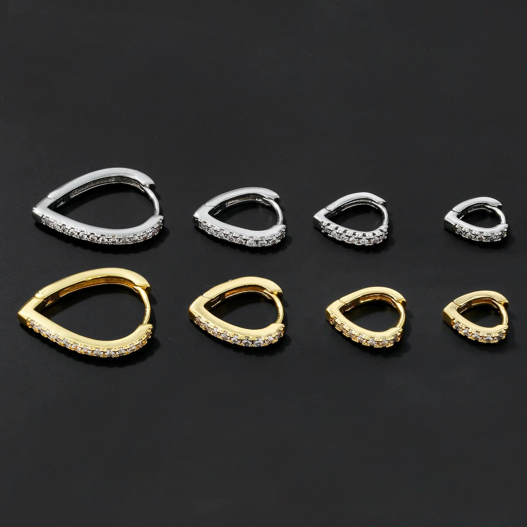 Copper geometric love heart ear clip with gold electroplating on white background