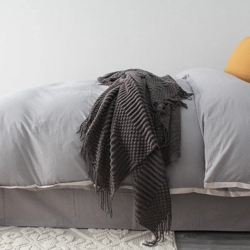 Small light grey polyester nap blanket folded, showing its 127cm by 170cm size.