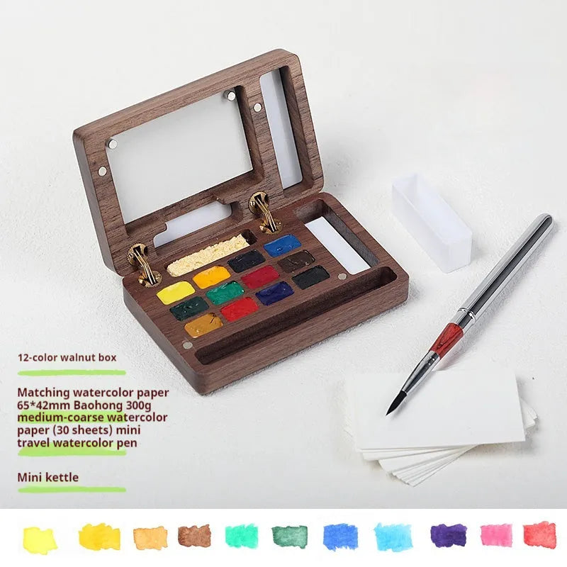 Mini wooden watercolour paint box with pigment suit inside, closed lid showing walnut-colour finish