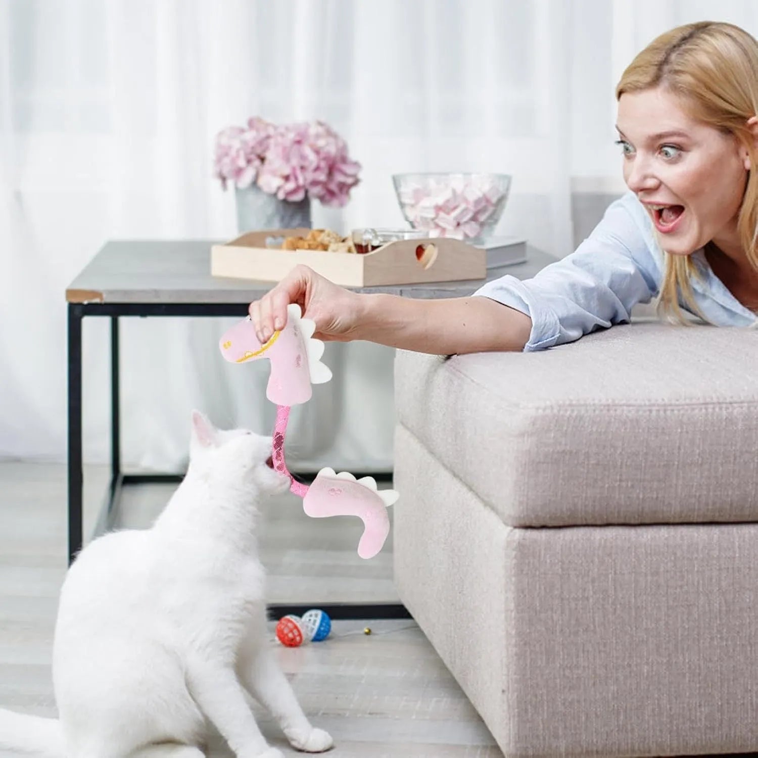 Set of four cat toys including chew toys, springs, rope toys, and kicker toys in pink, purple and yellow colours