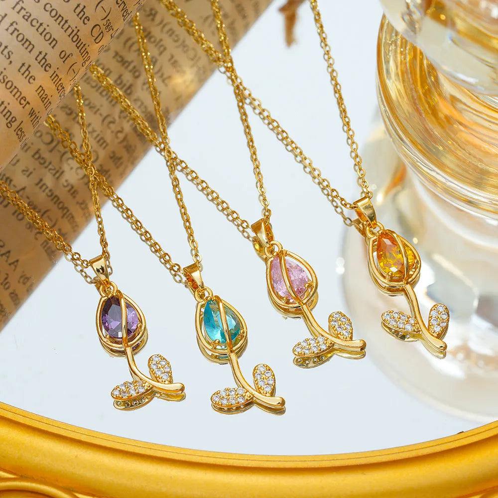 Gold zircon tulip flower pendant necklace on an adjustable titanium steel chain.