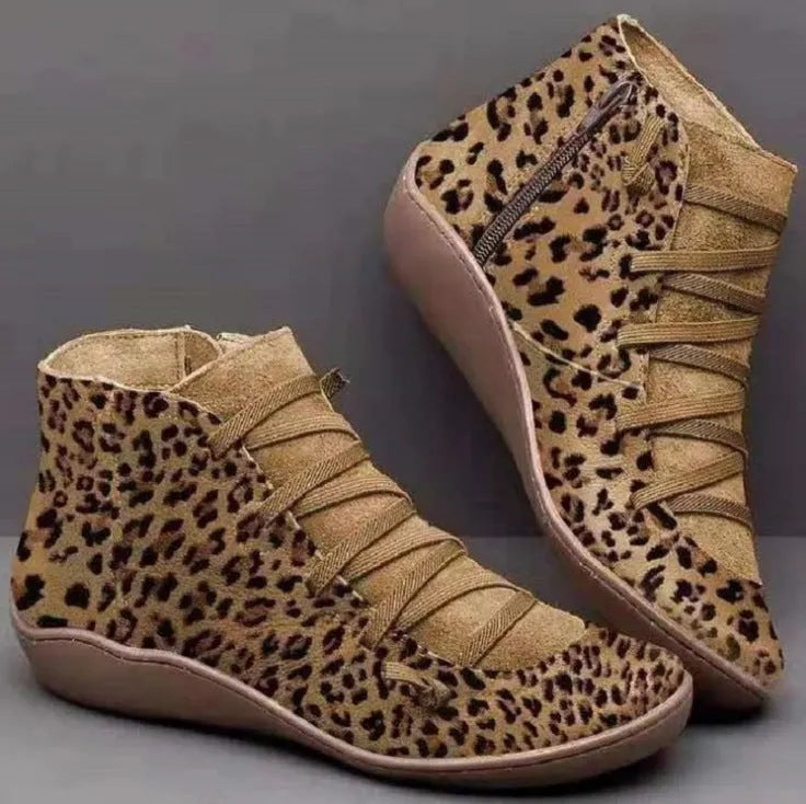 Women's casual flat ankle booties with a wedge heel and round toe in various colours.