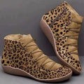 Women's casual flat ankle booties with a wedge heel and round toe in various colours.