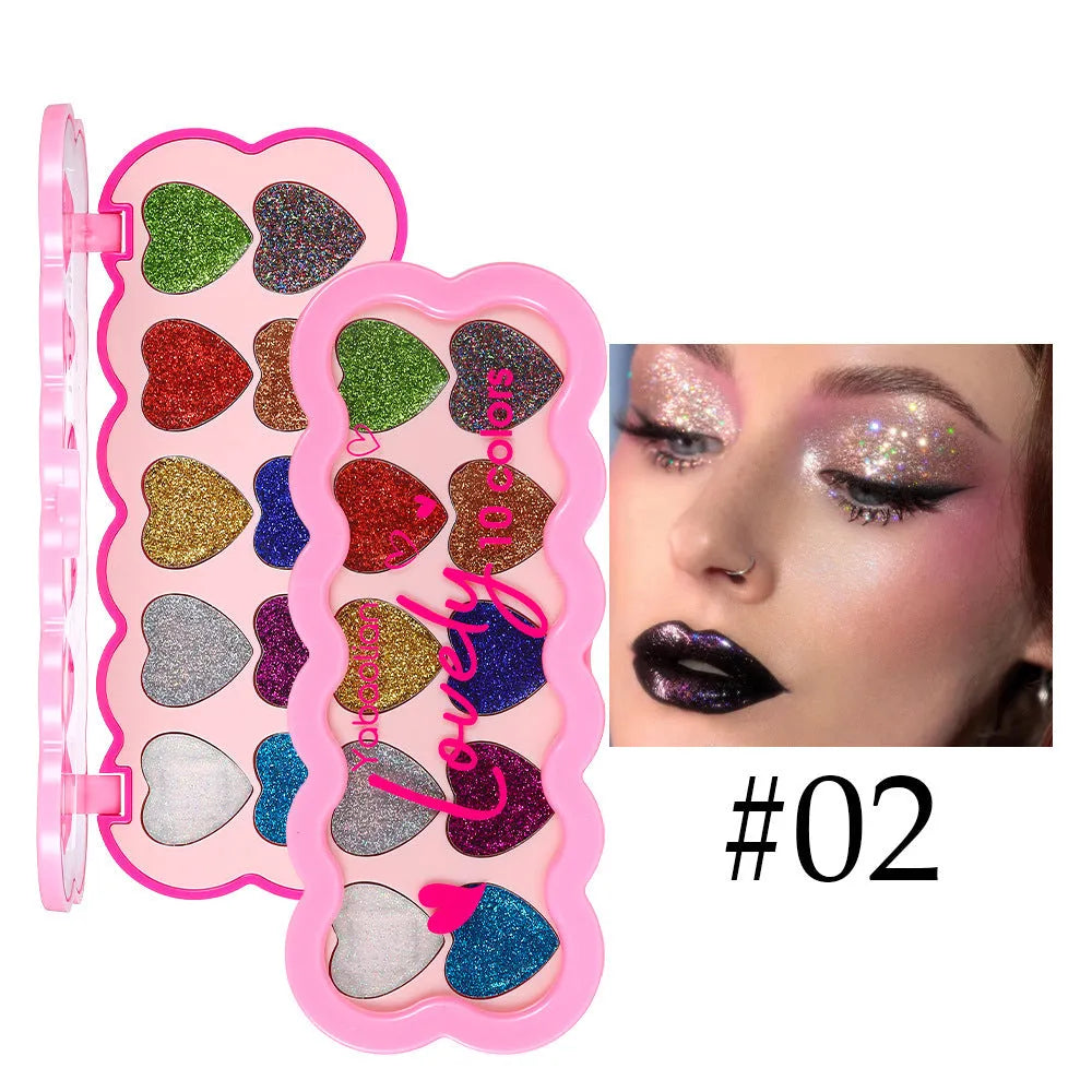 Pearlescent heart-shaped ten-colour sequin eyeshadow palette open, showing pink, blue, black, and coral shades.