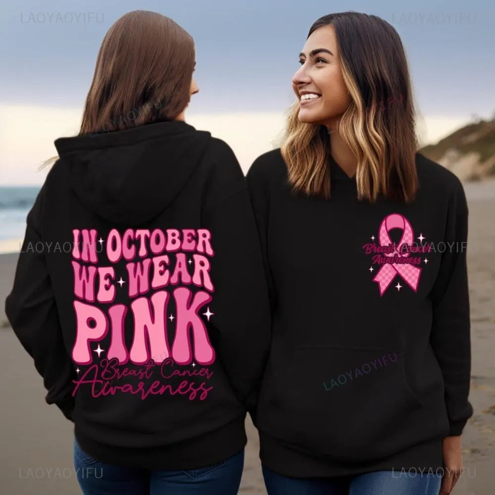 Pink pullover hoodie with a breast cancer awareness slogan, retro graphic, and side seam pockets.