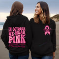 Pink pullover hoodie with a breast cancer awareness slogan, retro graphic, and side seam pockets.