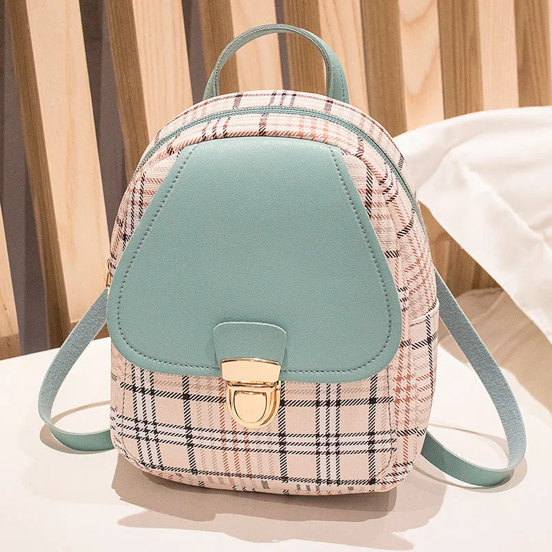 A black one shoulder diagonal phone bag made from PU fabric, shown being worn.