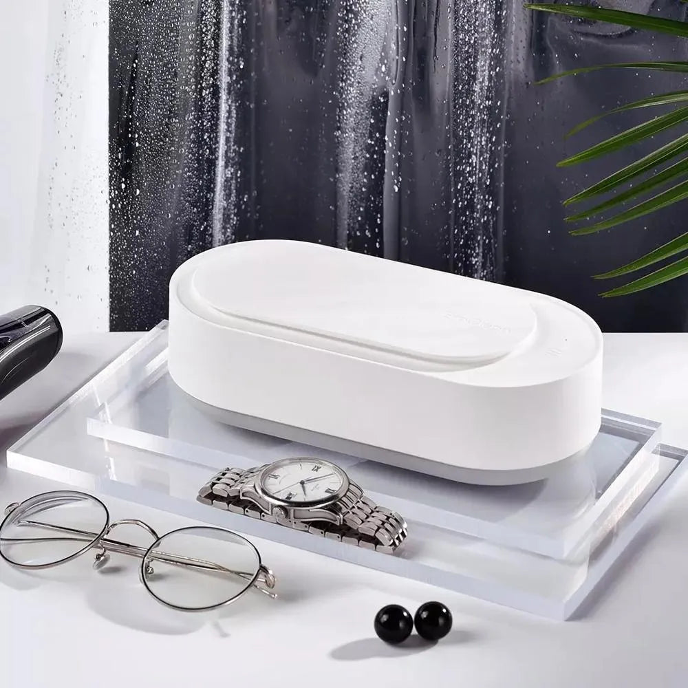 White portable ultrasonic cleaner machine with stainless steel tank for cleaning jewellery and glasses.