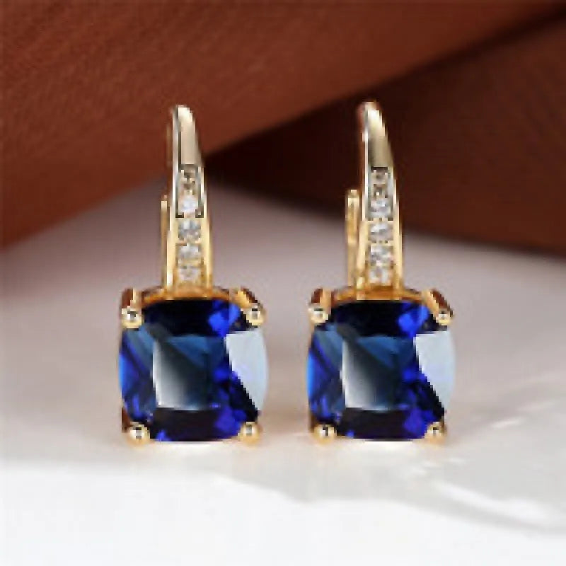 Geometric square copper ear clip earrings with moissanite inlays in a gold electroplated finish.