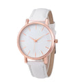 Square-faced quartz watch with a PU leather strap on a wrist, showing colour options like grey, pink, and blue.