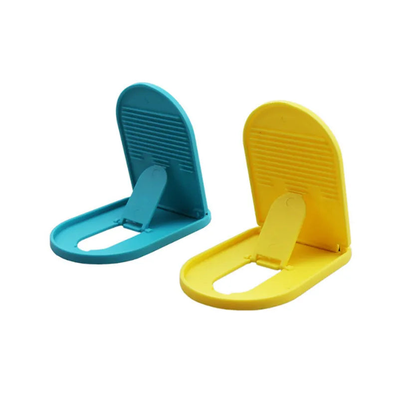 Plastic mobile phone stand with lazy bracket design in six colour options on a table.