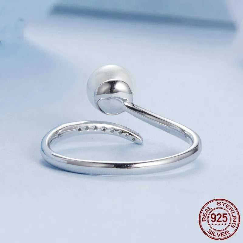Sterling silver adjustable ring with freshwater pearl on open-loop design