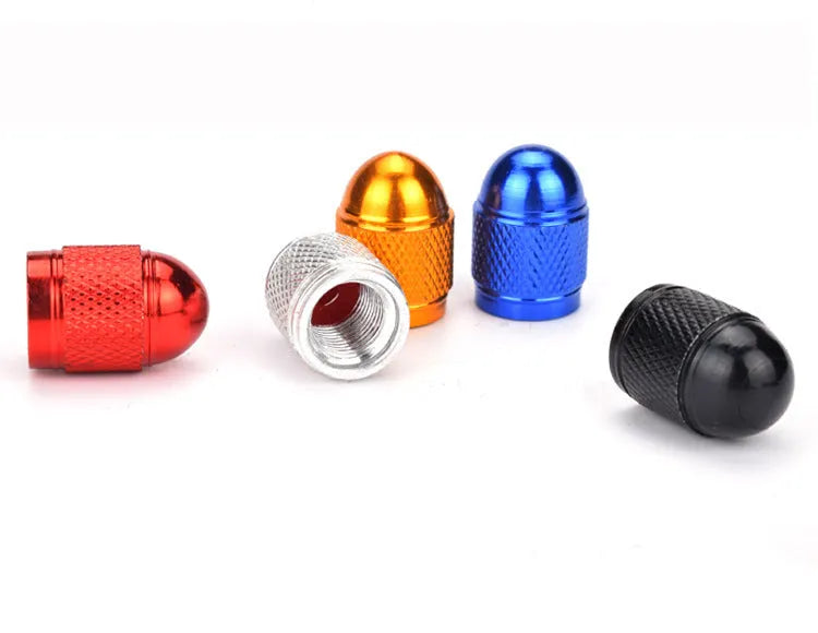 Aluminium alloy mountain bike tyre valve cap in gold, red, silver, blue, and black colours.