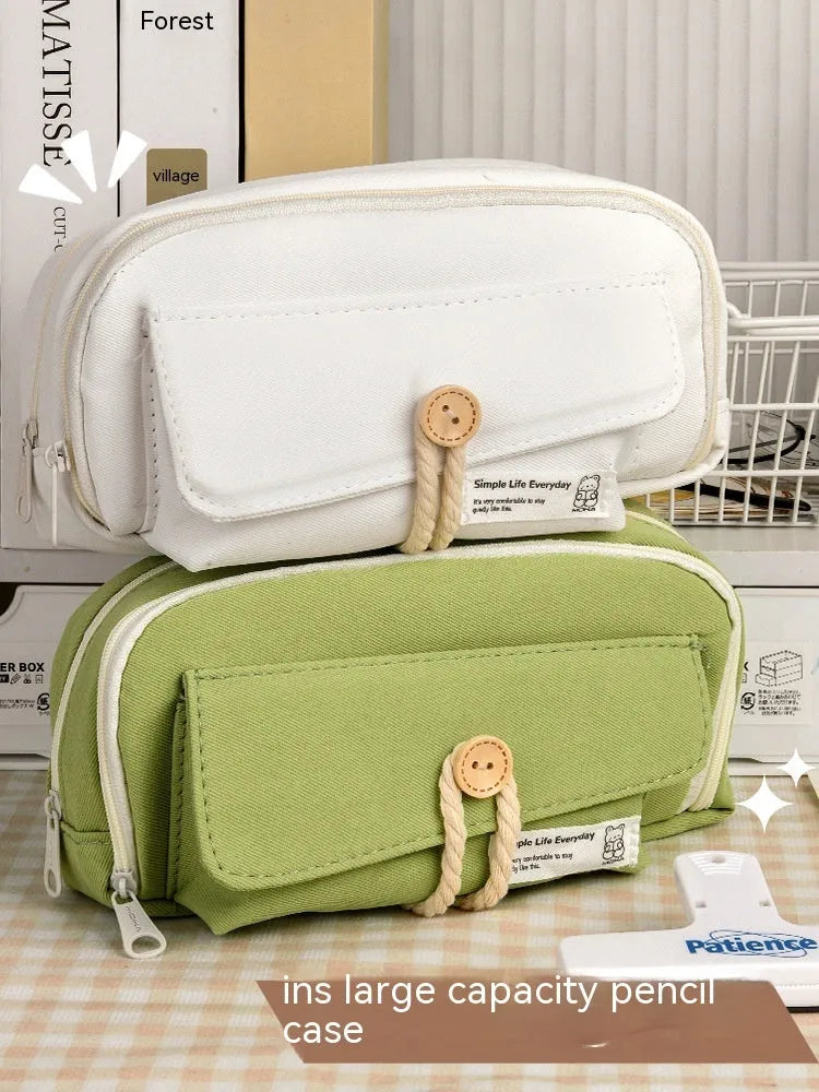 Large Korean-style canvas pencil case for girls in green, holding multiple pens.