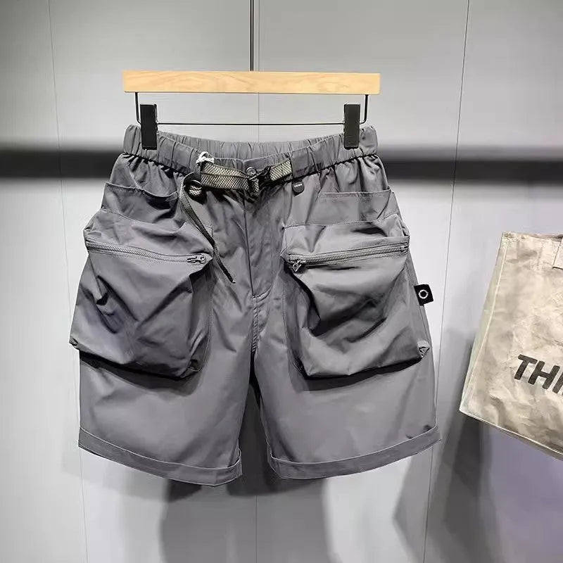 Men's black loose-fit cargo work shorts on a mannequin, showing multiple pockets and above-knee length.