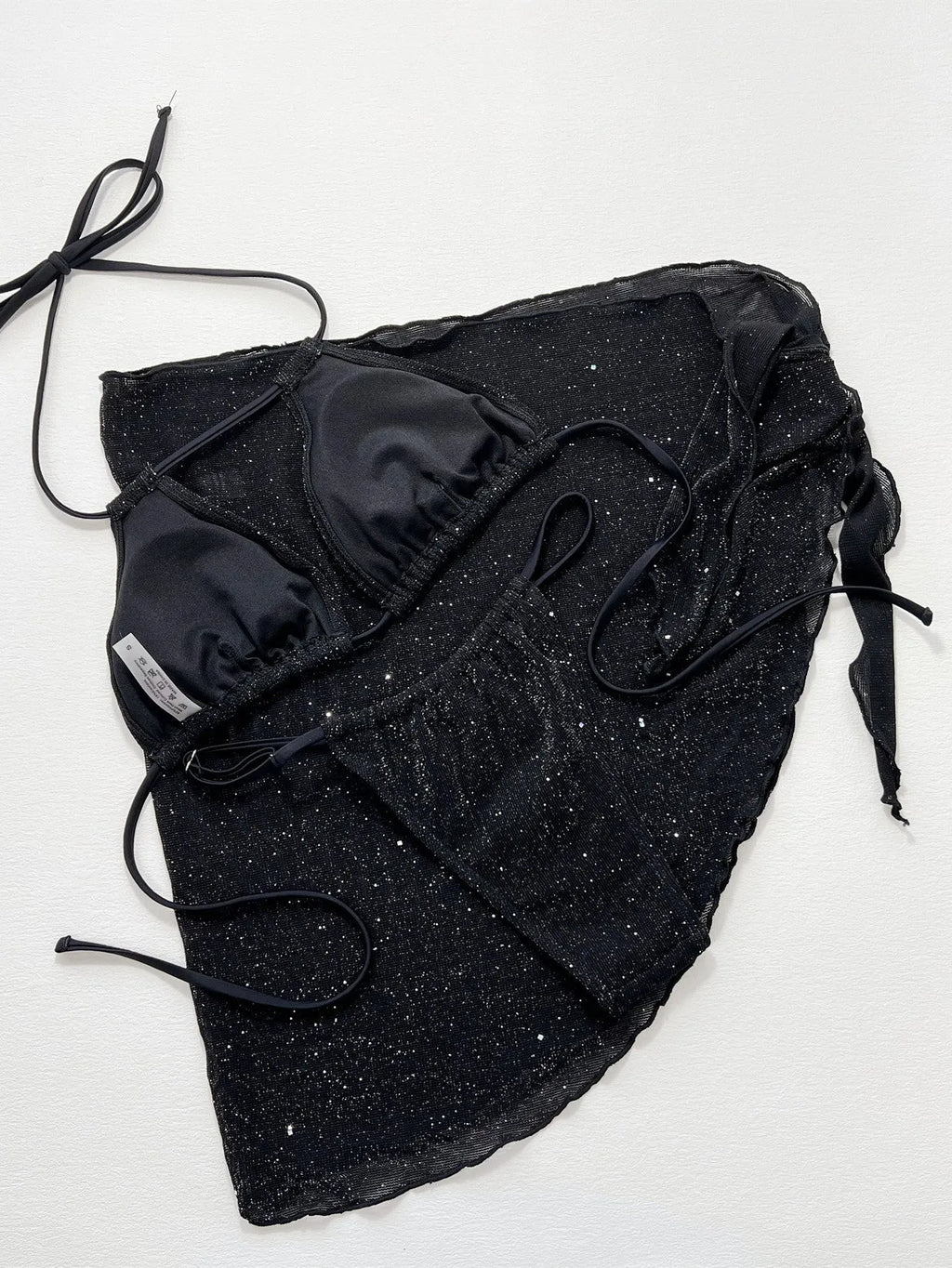 Black women's three-piece bikini swimsuit set with top and shorts.