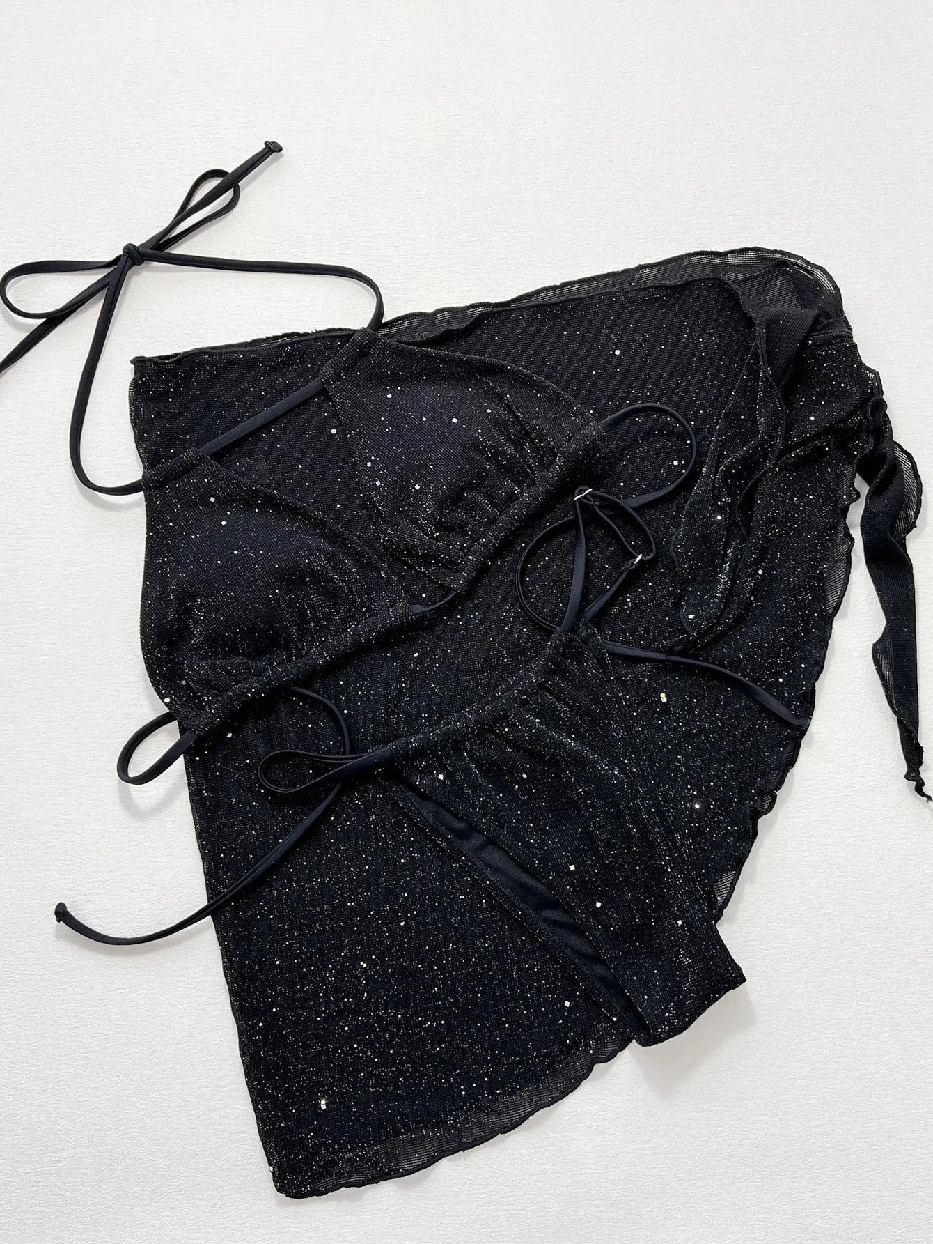 Black women's three-piece bikini swimsuit set with top and shorts.