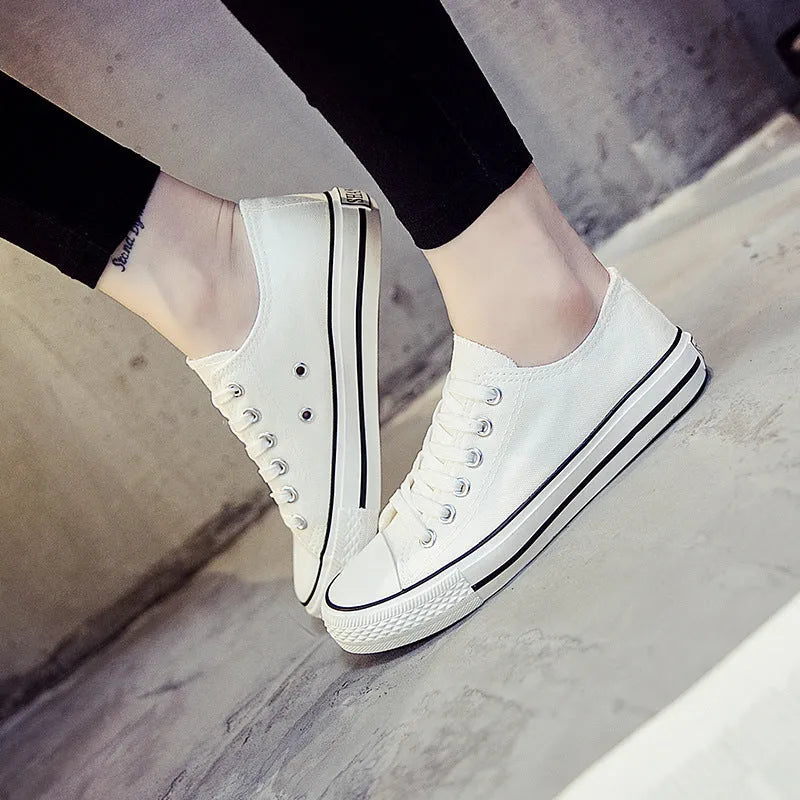 Women's solid-colour casual canvas shoes in black, white and black, white and red, or all black colourways.