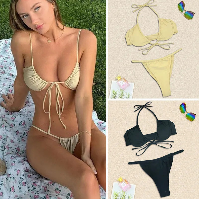 Women's black and mint green split bikini swimsuit on a hanger